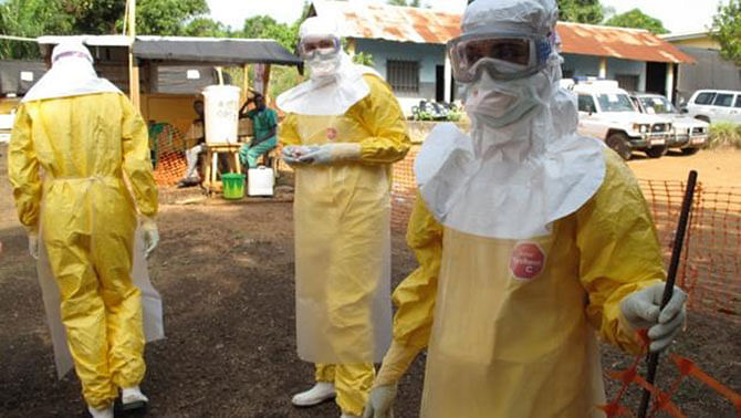 Nurse Monia Sayah and colleagues in protective clothing to treat Ebola patients at a Doctors Without Borders facility in Guinea. Photo taken from CBS News