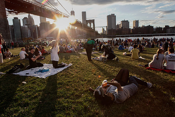 People wait to watch the annual Macy's fourth of July fireworks show looking over the East River on July 4, 2014 in the Brooklyn borough of New York City. Photo: Getty Images