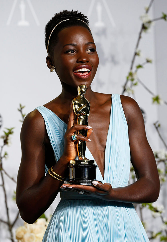 Lupita Nyong'o, poses with her award for best supporting actress for her role in 