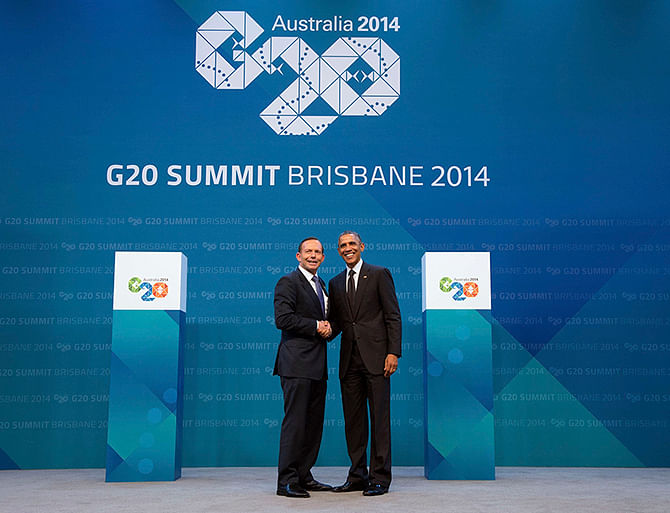 Australian Prime Minister Tony Abbott (L) shakes hands with U.S. President Barack Obama as he officially welcomes leaders to the G20 leaders summit in Brisbane, in this November 15, 2014 handout photo provided by G20 Australia. Photo: Reuters