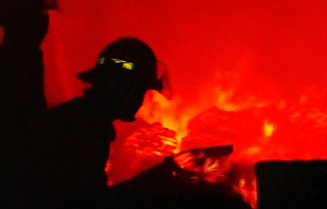 Firefighters are trying to bring the Otobi factory blaze under control in Savar last night. Photo: TV grab  