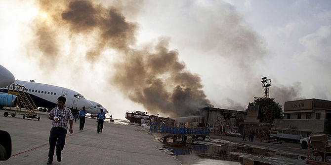 Smoke rises above Karachi airport terminal in Pakistan on Monday. Photo: AP