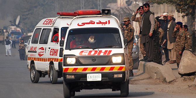 Ambulances drive away from a military run school that is under attack by Taliban gunmen in Peshawar, December 16, 2014. Taliban gunmen in Pakistan took hundreds of students and teachers hostage on Tuesday in a school in the northwestern city of Peshawar, military officials said. Photo: Reuters 