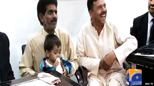Pakistani media aired footage of baby Musa sitting on his father's lap drinking milk in his first court appearance. Photo taken from BBC