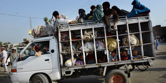 Pakistani civilians arrive by truck with their belongings and children in the neighborhood of Bannu, after fleeing North Waziristan tribal region in northwestern Pakistan on June 20 following a Pakistani army offensive against militants. Photo: Getty Images 