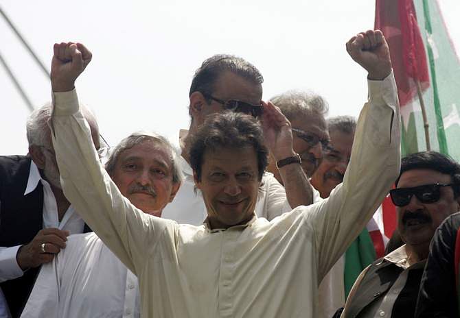 Imran Khan, chairman of Pakistan Tehreek-e-Insaf (PTI) political party, gestures as he leads the Freedom March in Lahore August 14, 2014. Thousands of protesters began to march on the Pakistani capital from the eastern city of Lahore on Thursday, buoyed by a last-minute court order that a peaceful march could go ahead and a government promise to obey the ruling. Photo: Reuters