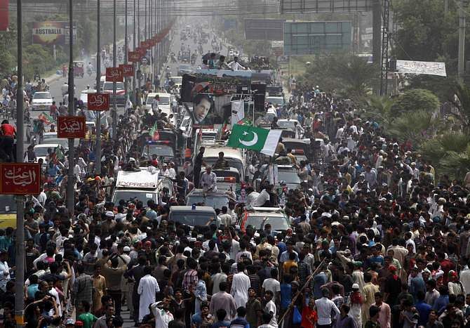 Supporters of cricketer-turned-opposition politician Imran Khan take part in the Freedom March in Gujranwala August 15, 2014. Clashes broke out Friday as tens of thousands of Pakistani protesters from two anti-government movements converged on the capital, presenting the 15-month-old civilian government with its biggest challenge yet. Photo: Reuters