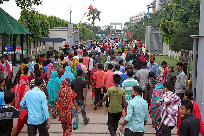 Amid strike call, garment workers are joining workplace today August 9, 2014 at a garment factory in Ashulia, outskirt of Dhaka. Photo: Palash Khan 