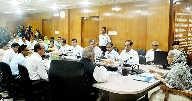 Prime Minister Sheikh Hasina holds a meeting with Industries Minister Amir Hossain Amu and other officials at the ministry on Sunday. Photo: BSS