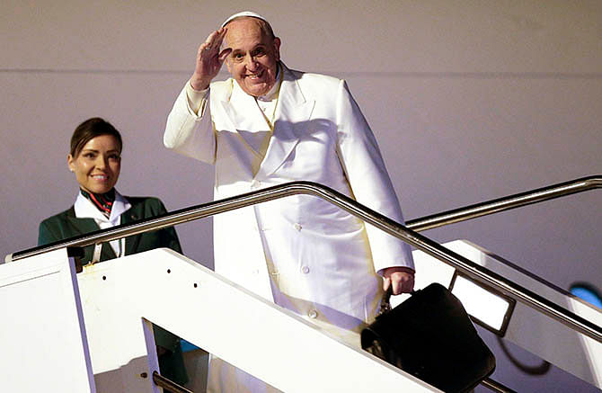 Pope Francis waves as he boards a plane for his trip to Sri Lanka and the Philippines at Fiumicino airport in Rome January 12, 2015. Photo: Reuters