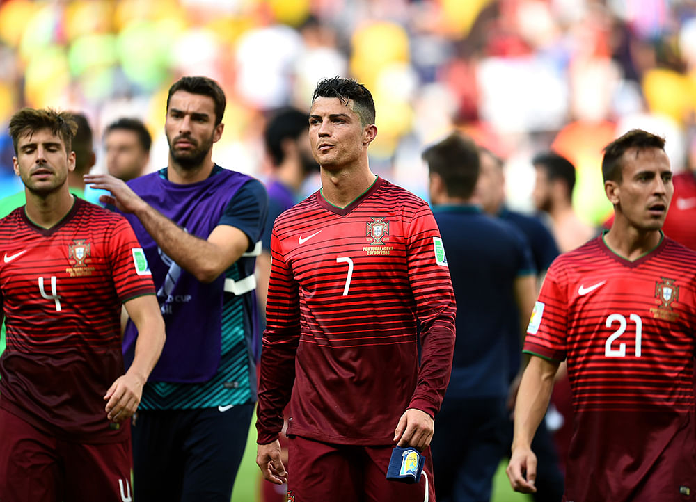 (L-R) Miguel Veloso of Portugal, Cristiano Ronaldo of Portugal and Joao Pereira of Portugal show their dejection after the 2014 FIFA World Cup Brazil Group G match between Portugal and Ghana at Estadio Nacional on June 26, 2014 in Brasilia, Brazil. Photo: Getty Images