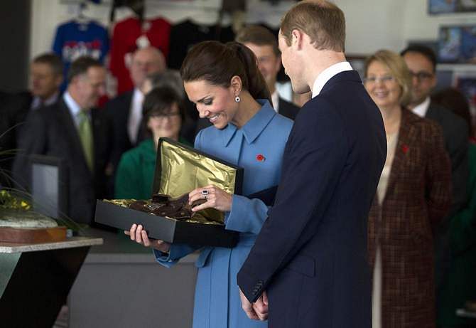 Britain's Prince William (R) looks with his wife Catherine, the Duchess of Cambridge, at a flying hat that was a gift for their son Prince George at the Omaka Aviation Heritage Center near Blenheim April 10, 2014. Photo: Reuters
