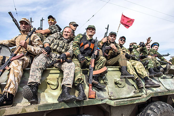 Pro-Russian rebels ride on an armored personnel carrier (APC) during a parade in Luhanks, eastern Ukraine, September 14, 2014. Photo: Reuters
