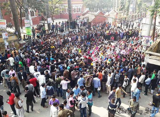 Rajshahi College students stage sit-in blocking a road in front of the college compound in the city protesting the death of their fellows. Photo: Star  