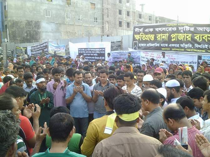 Relatives of Rana Plaza victims and garment workers offer munajat on Dhaka-Aricha highway at Savar Thursday morning marking a year of the building's tragedy that took place on April 24, 2013. They block the highway for four hours today. Photo: STAR   