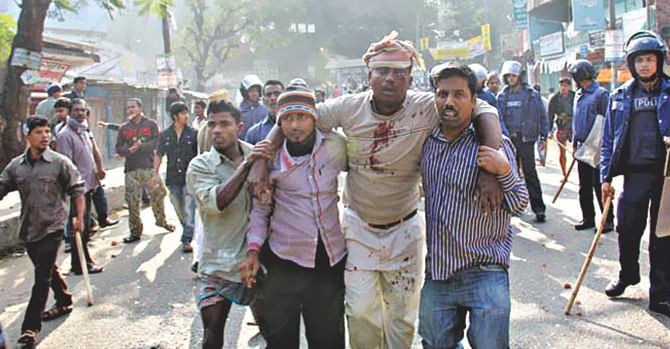 An inured man is being taken to a hospital after a clash between the activists of indigenous students' group Pahari Chhatra Parishad and pro-Awami League organisations over the inauguration of Rangamati Medical College on Saturday, January 11, 2015. 
