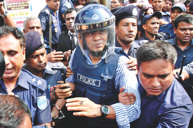 This May 18, 2014 photo shows Lt Col (retd) Tareque Sayeed Mohammad, ex-Rab official arrested over alleged involvement in the abduction and murder of seven people, being taken into police custody after he was produced before a court in Narayanganj.