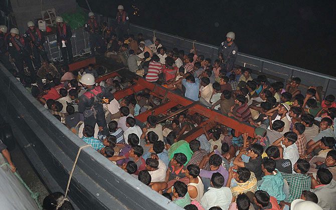 The Bangladeshi and Myanmarese fortune-seekers, who were rescued by Bangladesh Navy from a trawler in the Bay on Monday while going to Malaysia illegally, being drifted to Patenga in Chittagong Tuesday night. Photo: Star