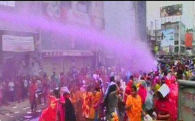 Law enforcers use water cannons to disperse the demonstrating workers of Toba group. Photo: TV grab 