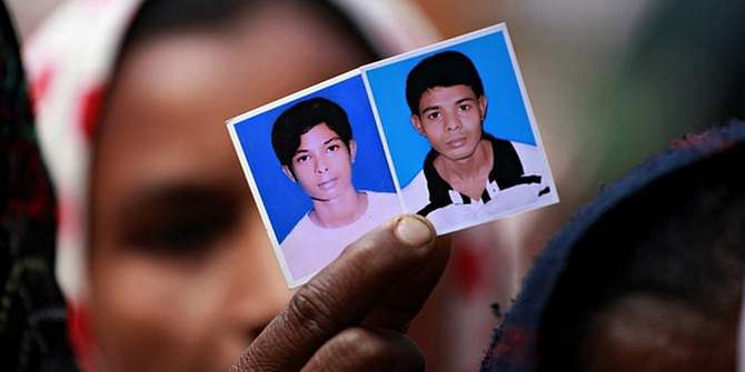 Relatives of victims killed in the Rana Plaza factory collapse hold their pictures. Photo: The Guardian