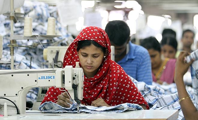 This Star file photo taken recently shows a female garment worker is busy threading clothes at a factory in Gazipur, Bangladesh.