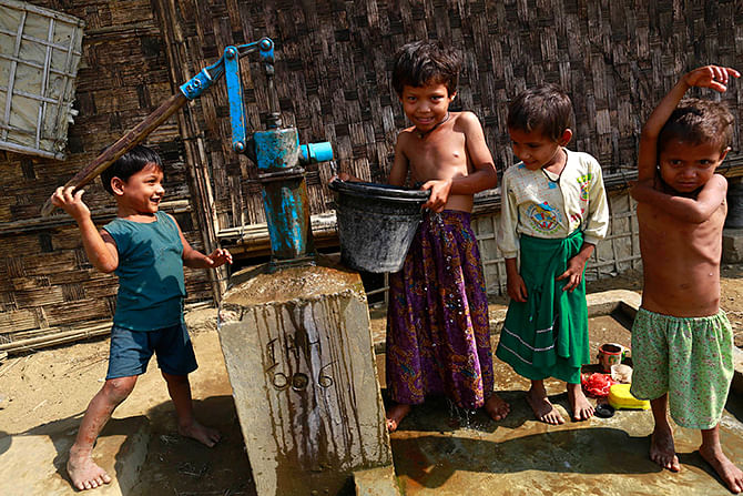 Rohingya children collect water at a Rohingya refugee camp outside Sittwe on Sunday. The Myanmar government will embark on its first national census in more than 30 years. Photo: Reuters