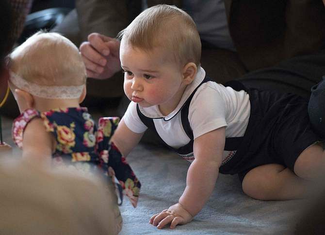Prince George, son of Britain's Prince William and his wife Catherine, the Duchess of Cambridge, looks at other babies during a Plunket nurse and parents group event at the Government House in Wellington April 9, 2014. Photo: Reuters
