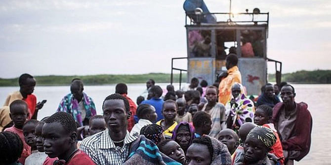 Displaced South Sudanese fleeing in boats at Minkammen. 