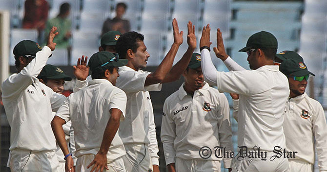 Shafiul Islam celebrates with teammates after dismissing Zimbabwe's H Masakadza on the third day of the third Test at Chittagong on Friday. Photo: Anurup Kanti Das