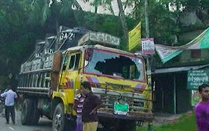 Locals vandalise a truck that run over two siblings on a road in Satkhira Sadar upazila Sunday. Photo: TV grab