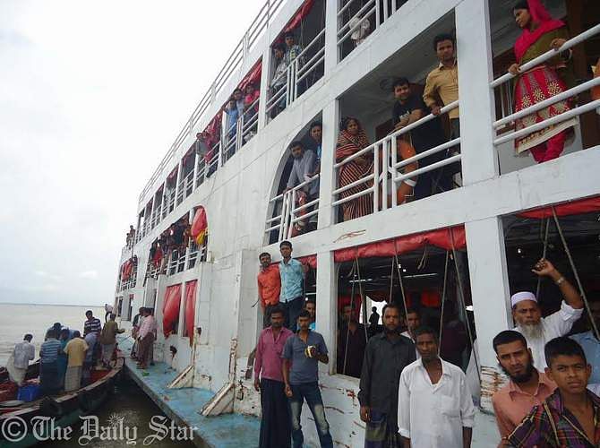 Passengers of stuck MV Sattar Khan are being rescued with help of trawlers and another launch on Saturday. 1,165 passengers of the launch that got stuck in Meghna river after hitting a hidden shoal in Haim Char upazila of Chandpur last night, were rescued after 14 hours. Photo: STAR