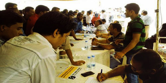 This file photo shows Bangladeshi workers crowd counters of companies participating in a job fair organised by Bangladesh embassy in Riyadh.