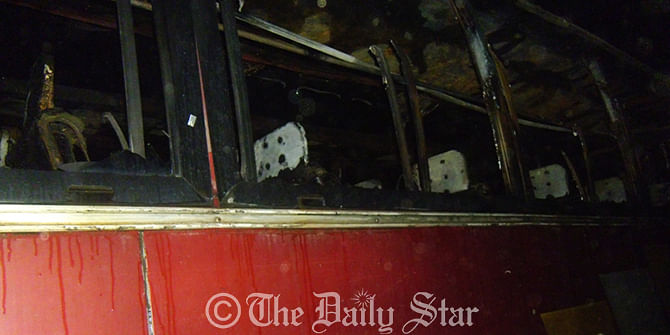Interior of a bus is completely destroyed in the fire after unidentified miscreants hurled a petrol bomb at it in Savar Thursday evening. Photo: Star