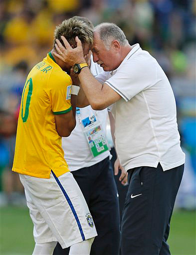 Brazil's coach Luiz Felipe Scolari embraces Brazil's Neymar after the World Cup round of 16 soccer match between Brazil and Chile at the Mineirao Stadium in Belo Horizonte, Brazil on June 28. Photo: AP 