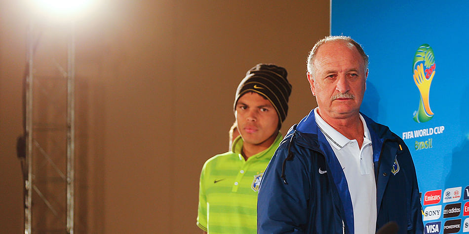 Brazil's coach Luiz Felipe Scolari (R) and defender and team captain Thiago Silva arrive to hold a press conference at the Mane Garrincha National Stadium in Brasilia on July 11, 2014 on the eve of the 2014 FIFA World Cup football match for third place between Brazil and the Netherlands. Photo: Getty Images