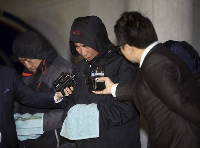 Journalists ask Lee Joon-seok (C), captain of South Korean ferry 