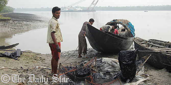 Locals collecting furnace oil spilt from a drowned tanker in the Shela river along Sundarbans on Friday. The oil was spilled from an oil tanker that sank in the Shela river in Bagerhat last Tuesday. Photo: Star