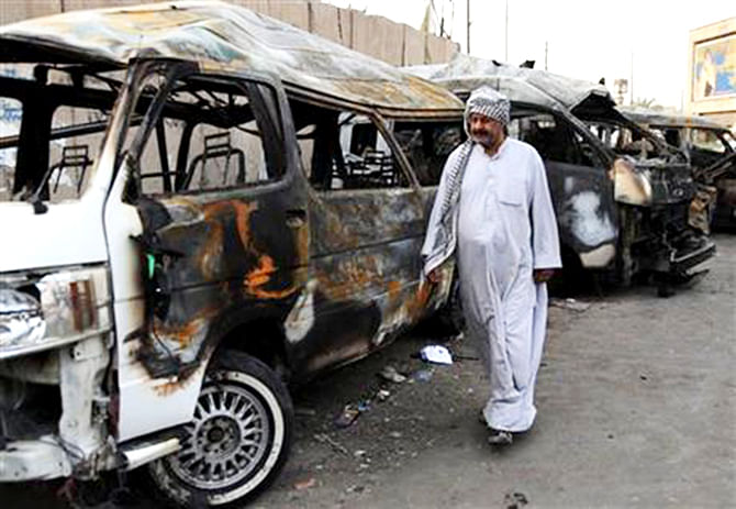A man looks at the site of a car bomb attack in the Shula neighborhood of Baghdad, Iraq, October 12, 2014. Photo: AP