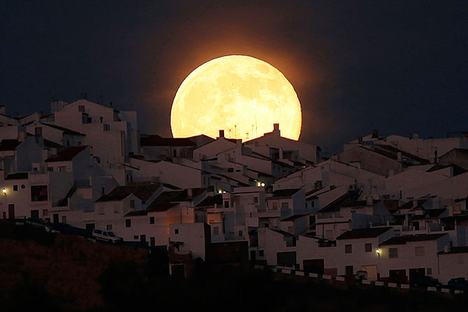 The Supermoon rises over houses in Olvera, in the southern Spanish province of Cadiz, July 12, 2014. Occurring when a full moon or new moon coincides with the closest approach the moon makes to the Earth, the Supermoon results in a larger-than-usual appearance of the lunar disk. Photo: Reuters