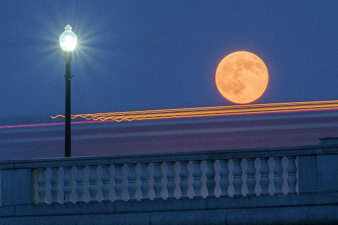 Supermoons look most striking against backdrops of trees and buildings, because they gives our brains a reference for the moon’s size. Photo: AP