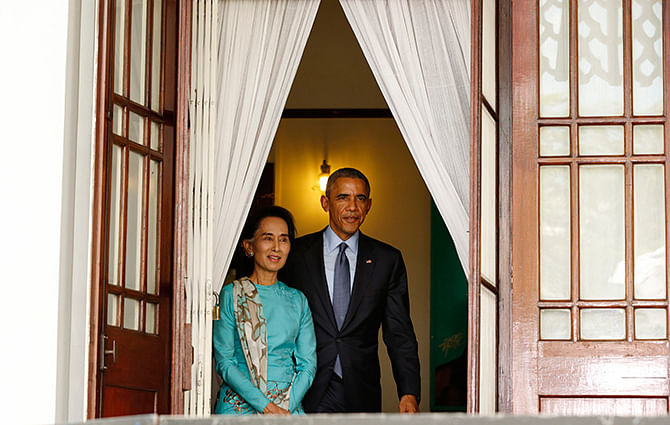 US President Barack Obama and opposition politician Aung San Suu Kyi step outside to hold a press conference after their meeting at her residence in Yangon, November 14, 2014.