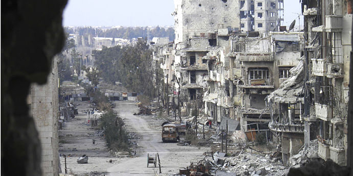 Damaged buildings line a deserted street in the besieged area of Homs January 9, 2014.