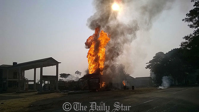  A tank-lorry is seen burning near a petrol pump on Dhaka-Tangail highway at Motra in Tangail Tuesday morning. The fire originated in the lorry when a truck hit it. Photo: STAR