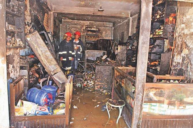 This April 11 photo shows firemen inspecting the devastated shop after the chemical explosion at Tejturi Bazar in the capital. 