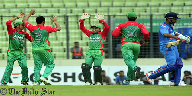 Tigers celebrate after falling of a wicket of visiting India in the second one-day international (ODI) at Mirpur in Bangladesh capital Dhaka today. Photo: Firoz Ahmed    