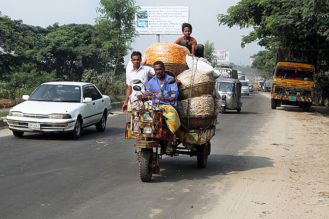 A Nasiman, locally made three-wheeler vehicle, plies a road carrying goods and people in the country. Star file photo