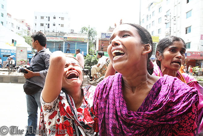 The workers of Tuba Group cry in front of the factory in North Badda of Dhaka on Thursday after law enforces attack on them to break an 11-day hunger strike for unpaid salaries and bonuses. Photo: Star