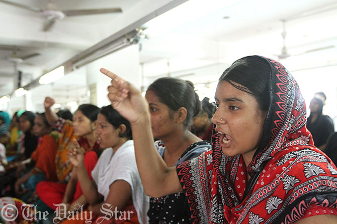 Garment workers of Tuba Group chant slogans demanding their outstanding salary and bonus at the factory premises in capital’s Badda on Thursday. Photo: Palash Khan