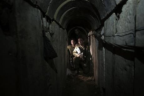 In this October13, 2013 file photo, Israeli soldiers walk through a tunnel discovered near the Israel Gaza border. Photo: AP