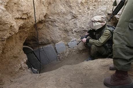 In this October 13, 2013 file photo, Israeli soldiers enter a tunnel discovered near the Israel Gaza border. Photo: AP